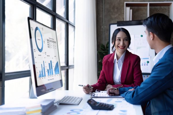 Young Asian business team creative businesspeople coworker in office. Meeting Presentation for tax analysis graph company financial. People Work in Business Office.